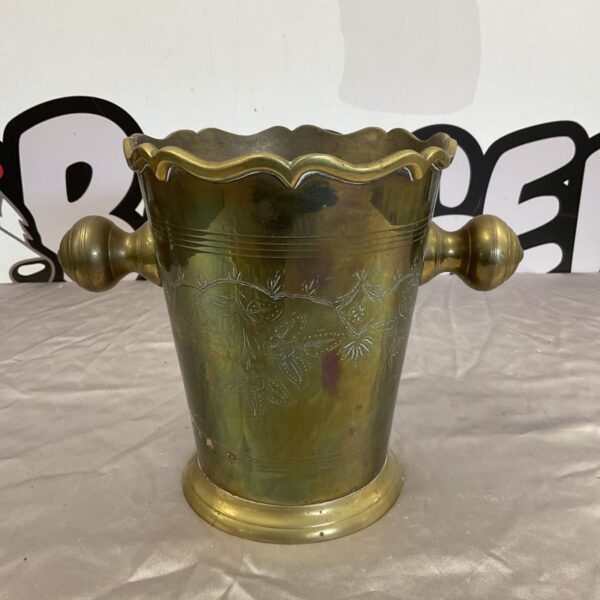 Vintage brass champagne bucket with floral embossed details.