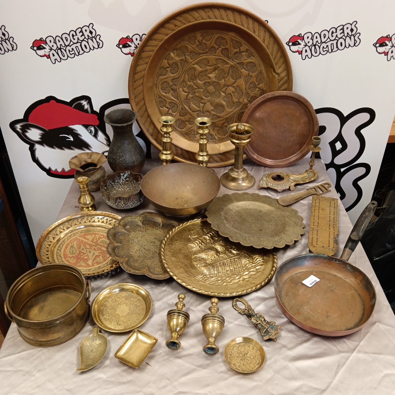 Vintage brass and copper lot with trays, bowls, and candlesticks.