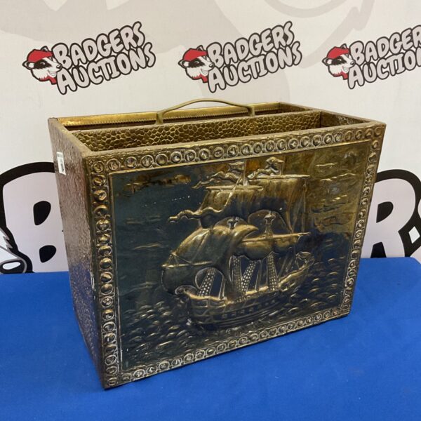 Vintage brass ship magazine rack with detailed nautical design.