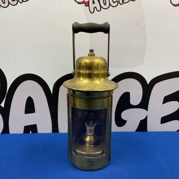 Vintage brass ships lantern with glass enclosure.