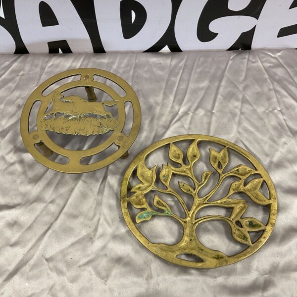 Vintage brass trivet with Tree of Life design, detailed metalwork.
