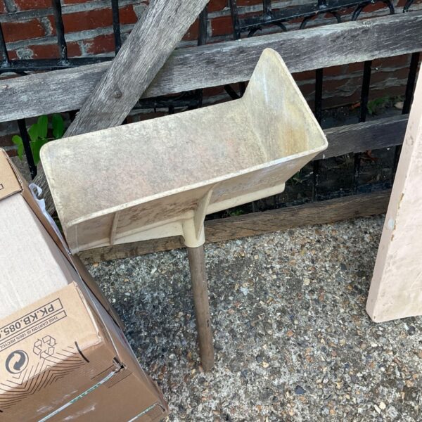 Vintage bricklayers hod showing wear and age.