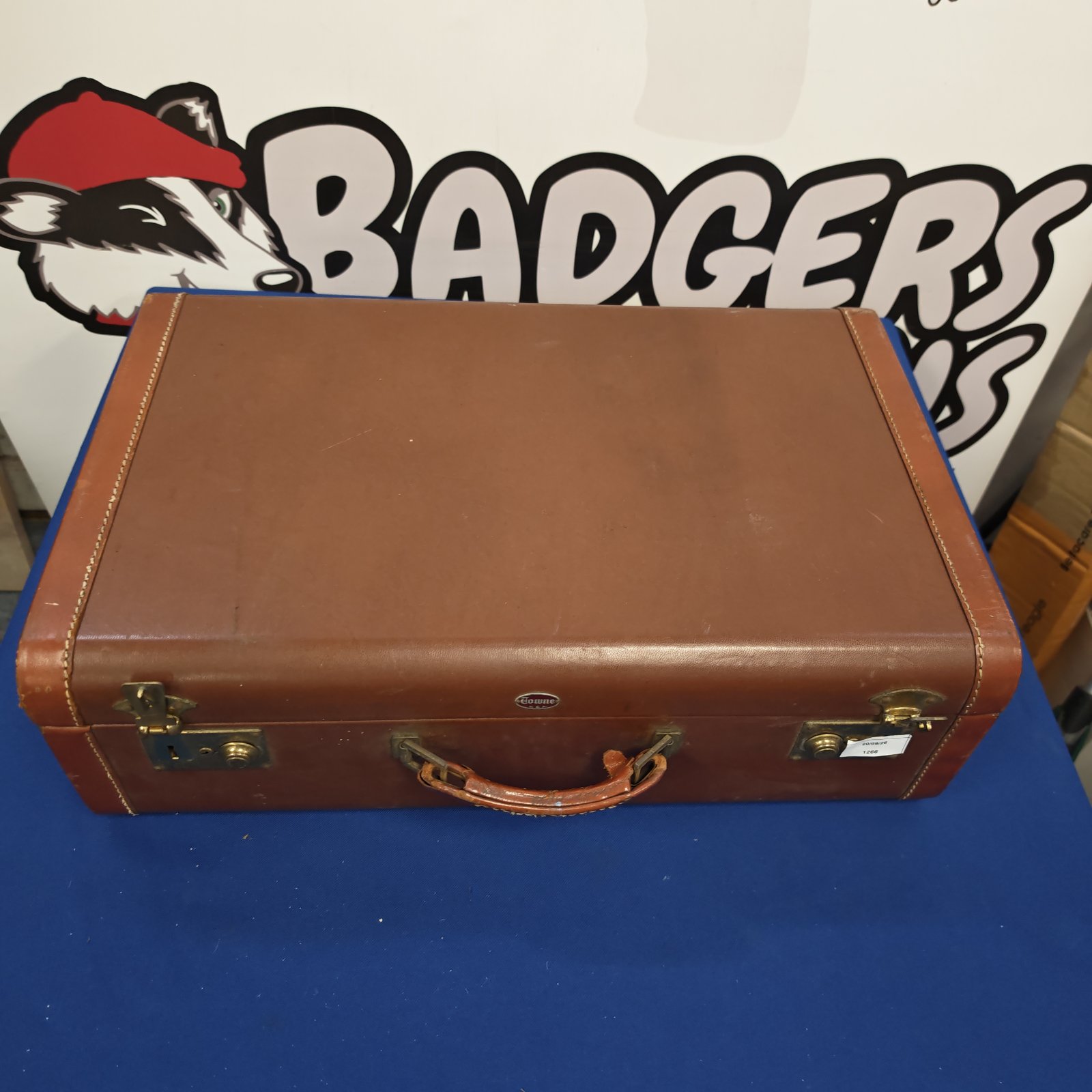 Vintage brown leather suitcase with a classic travel aesthetic.