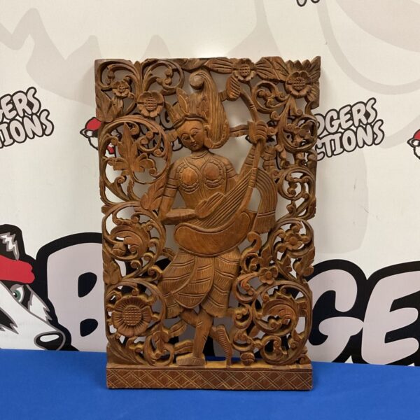 Vintage carved wooden Buddhist wall plaque with ornate details.