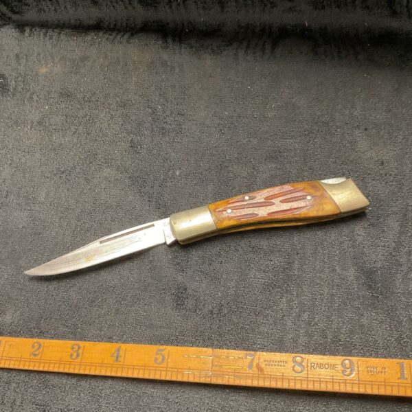 Vintage Burton McCall folding knife with horn handle and ruler.
