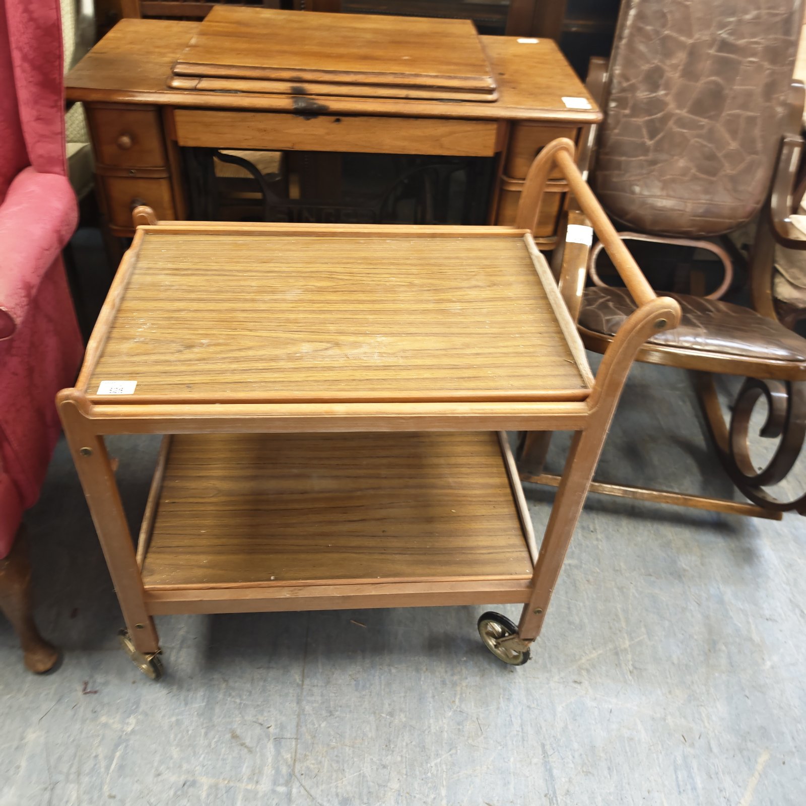 Vintage wooden butlers trolley with two tiers and curved handles.