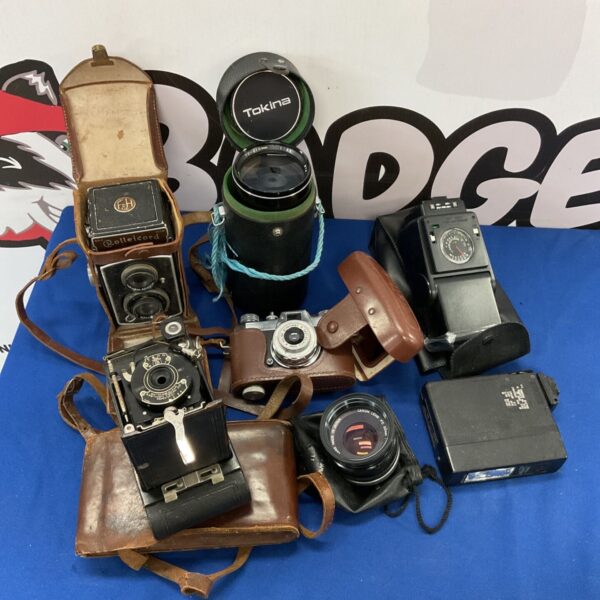 Vintage camera collection featuring a Rolleicord and Halina camera.