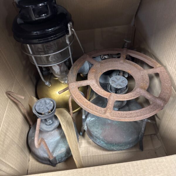 Vintage camping lantern with enamel finish and protective cage.
