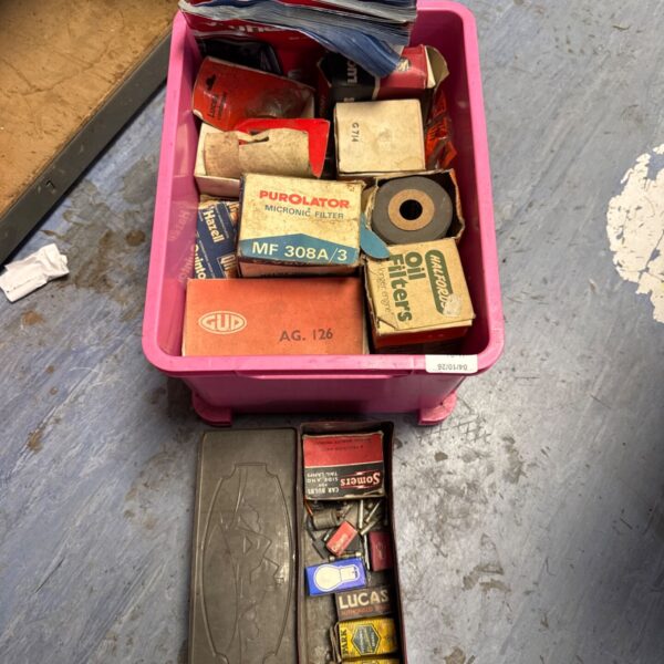 Vintage car parts lot including oil filters and auto bulbs.