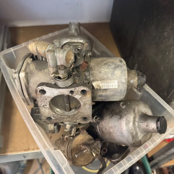 Vintage carburettor FZX422 in a plastic storage box.