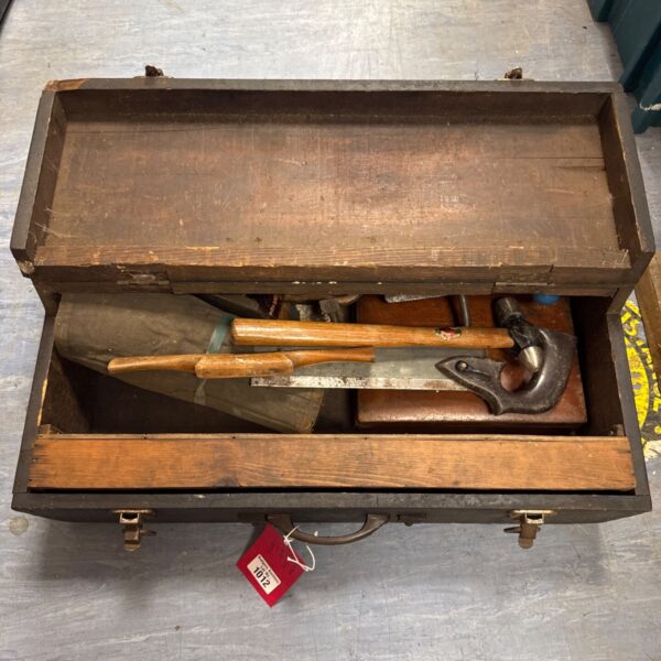 Vintage carpenter's toolbox filled with antique woodworking tools.