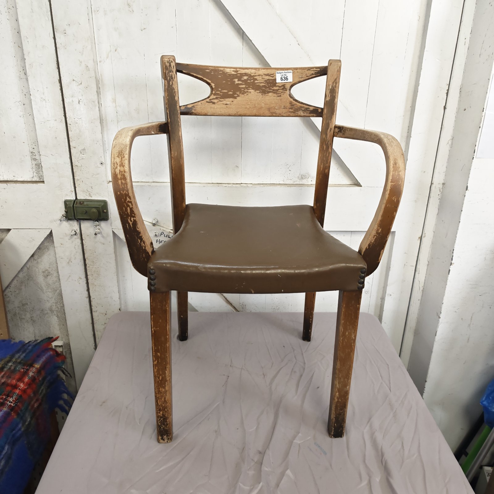 Vintage carver dining chair with leather seat and stud detailing.
