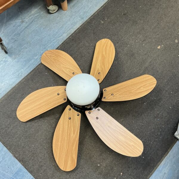 Vintage ceiling fan unit with wooden blades, a classic home decor item.