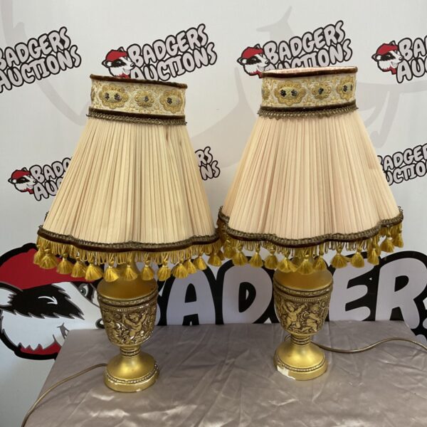 Vintage gilded cherub table lamps, a charming pair for home decor.