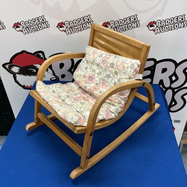 Vintage children’s rocking chair with patterned woven seat.