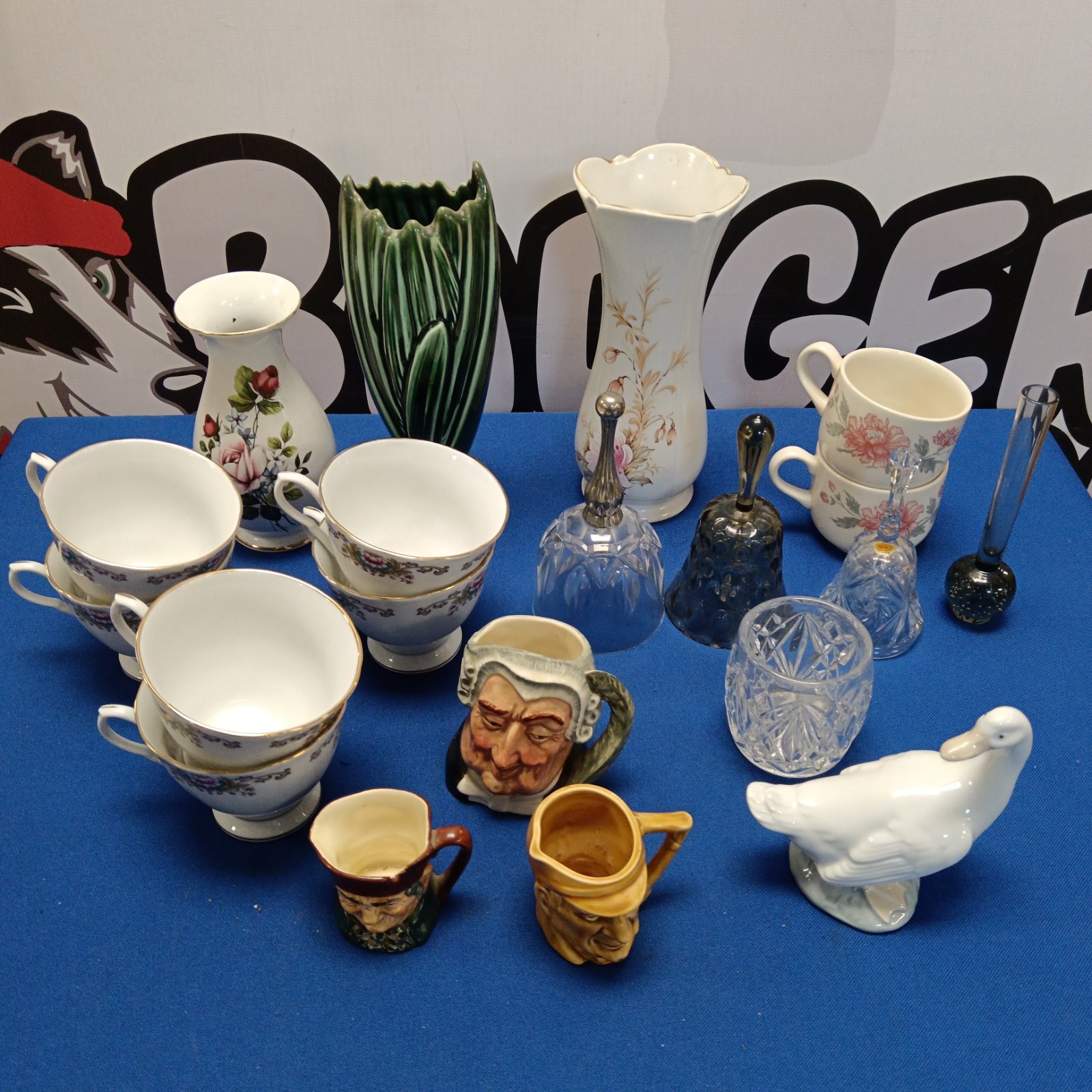 Mixed vintage china collection including teacups and figurines.