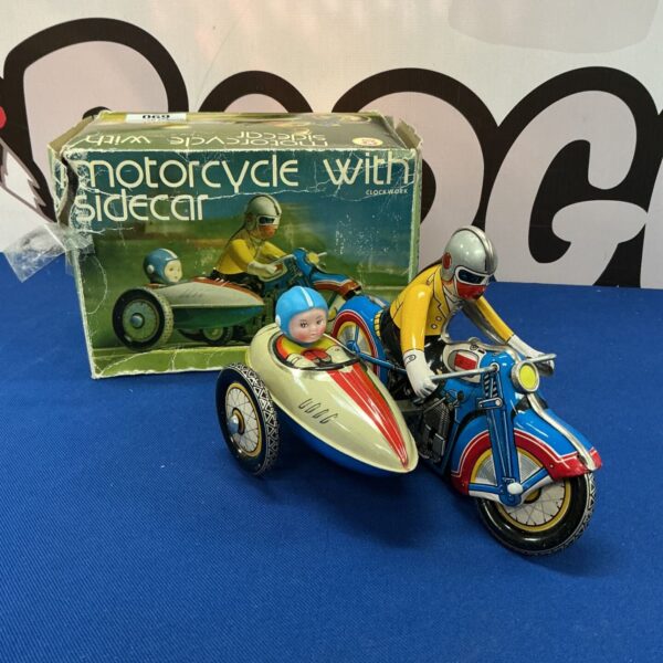 Vintage clockwork motorcycle with sidecar tin toy.