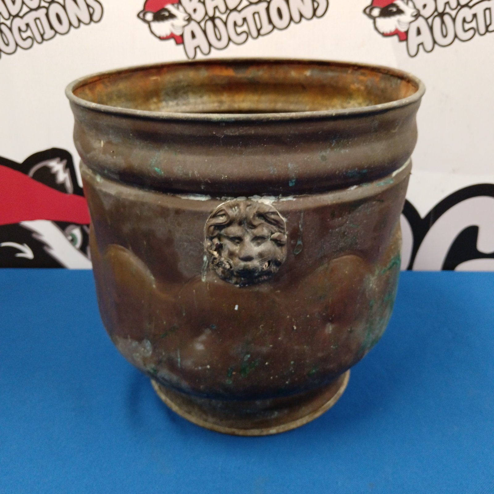 Vintage copper jardiniere with detailed lion head handles.