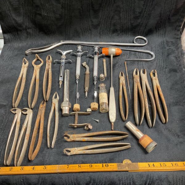 Vintage dental tools collection, including forceps and elevators.