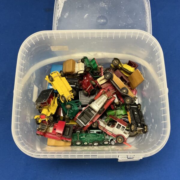Vintage diecast cars in a plastic tub, including Matchbox models.