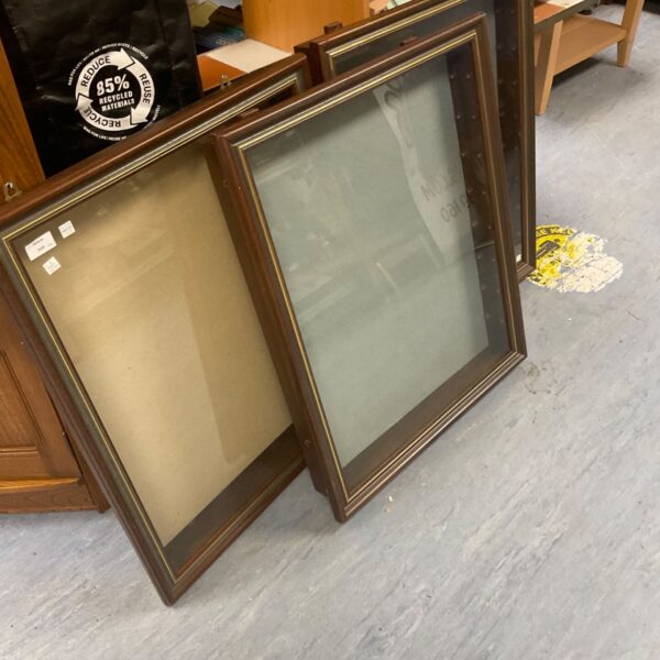 Vintage display cabinet glass with dark wood frame.