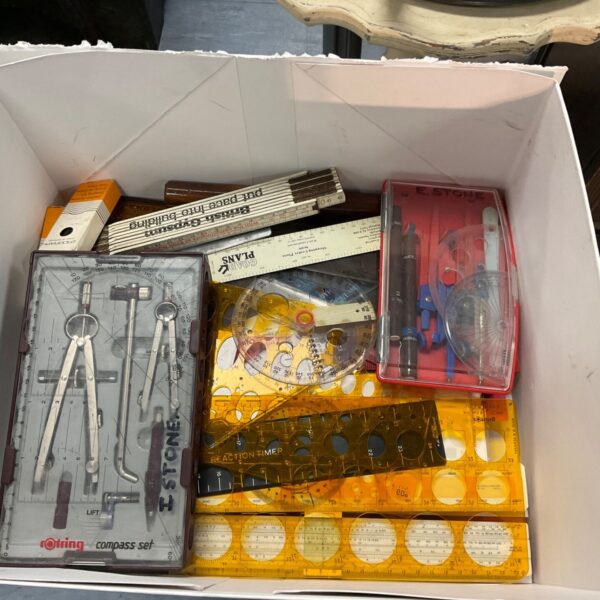 Vintage drawing compass sets in a box, ideal for collectors.
