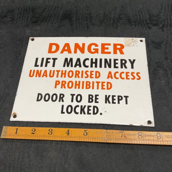 Vintage enamel danger sign for lift machinery access prohibition.