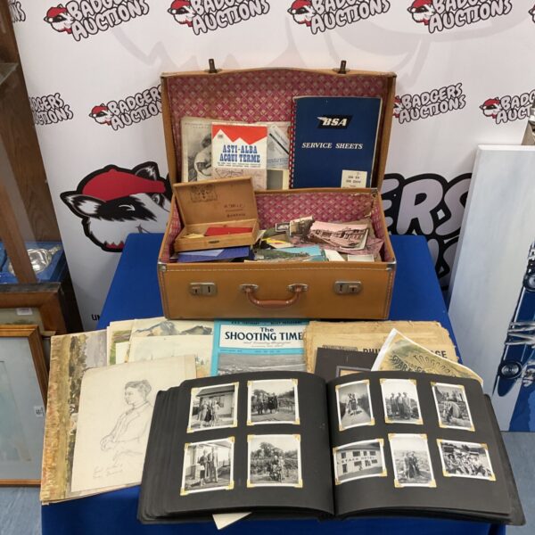 Vintage leather case filled with a photo album and ephemera.
