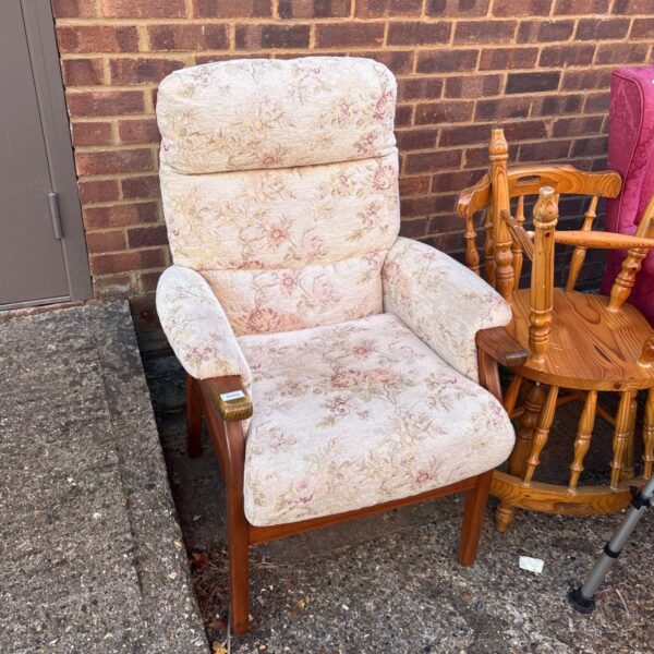 Vintage floral armchair with wooden frame and patterned upholstery.