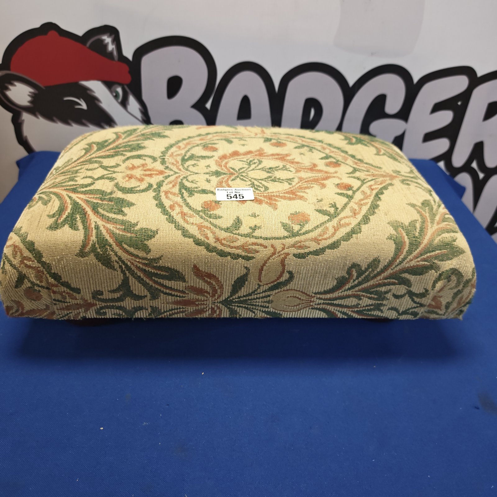 Vintage floral footstool with a colourful pattern.