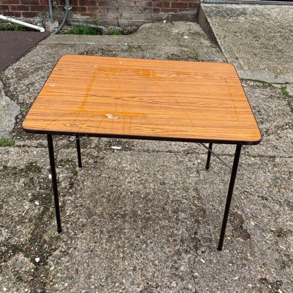 Vintage folding Formica table with orange patterned top.