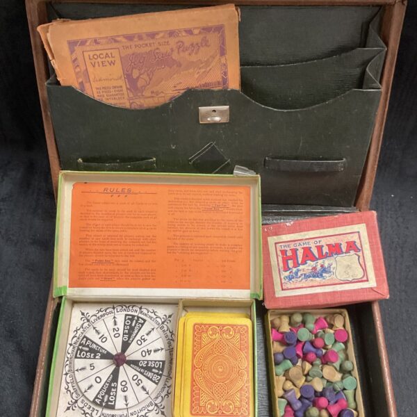 Vintage leather case filled with antique games collection.