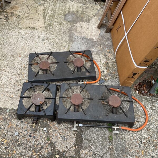 Vintage gas burner rings, likely Fokker, showing signs of wear.