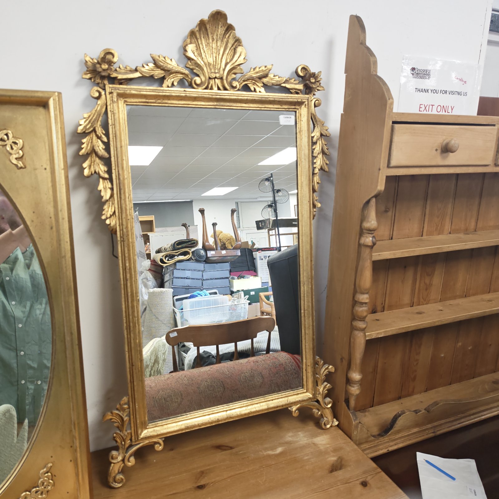 Ornate vintage gilt mirror with shell crest and acanthus leaves.