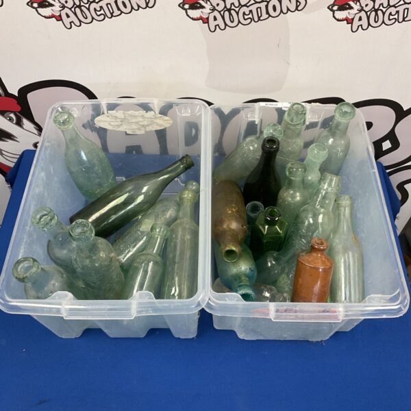 Vintage glass bottle collection with green and brown bottles.