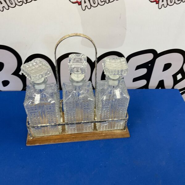 Vintage glass decanter set on a metal tray.