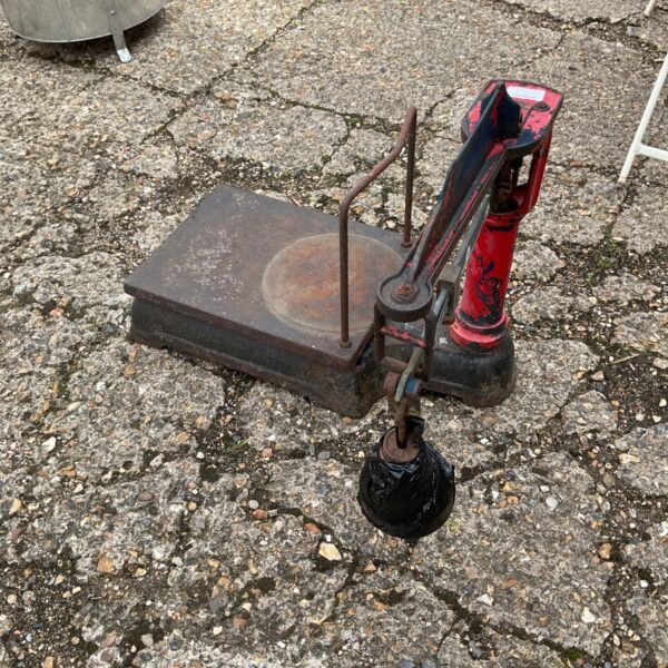 Antique grain scale with metal platform and hanging weight.