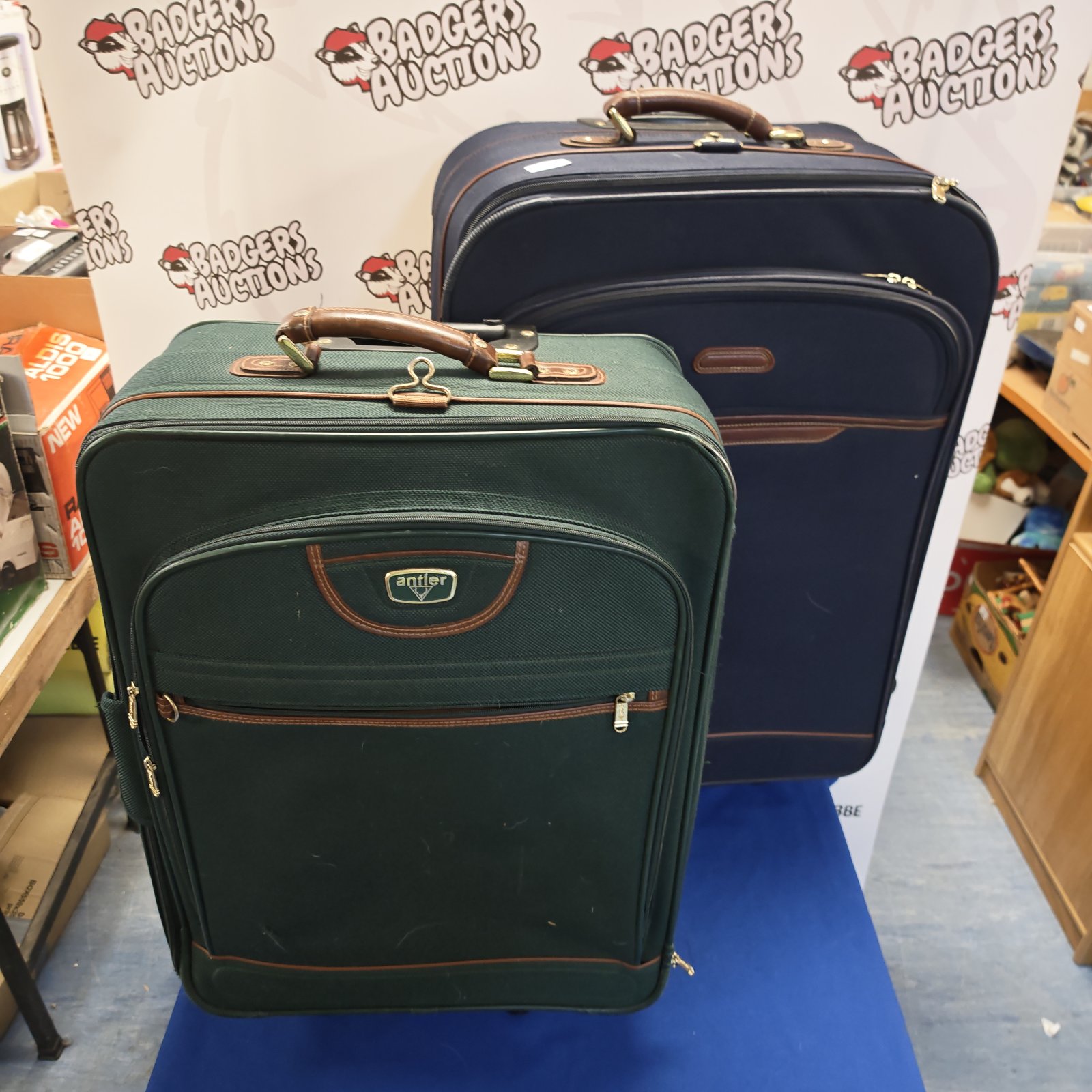 Vintage green wheeled suitcase with extending handle for travel.
