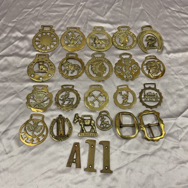 Vintage horse brasses and belt buckles collection, equestrian themed brassware.