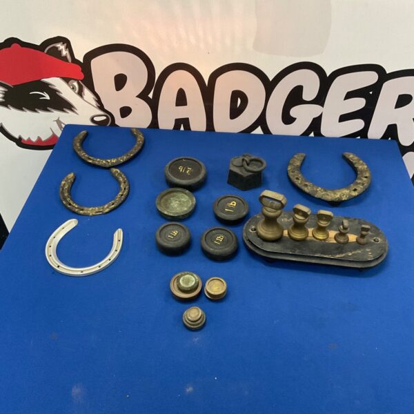 Vintage horse shoes and iron weights, antique fitness equipment.