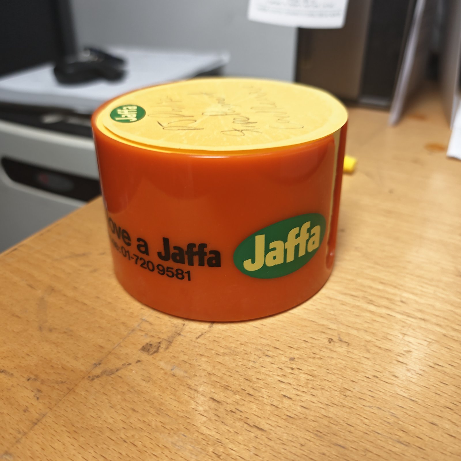 Vintage orange Jaffa holder with model number visible.