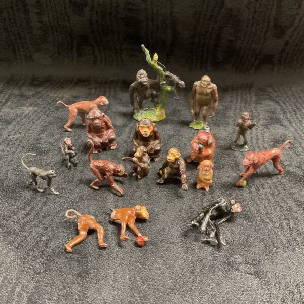 Group of vintage lead monkey figures, collectible toys.