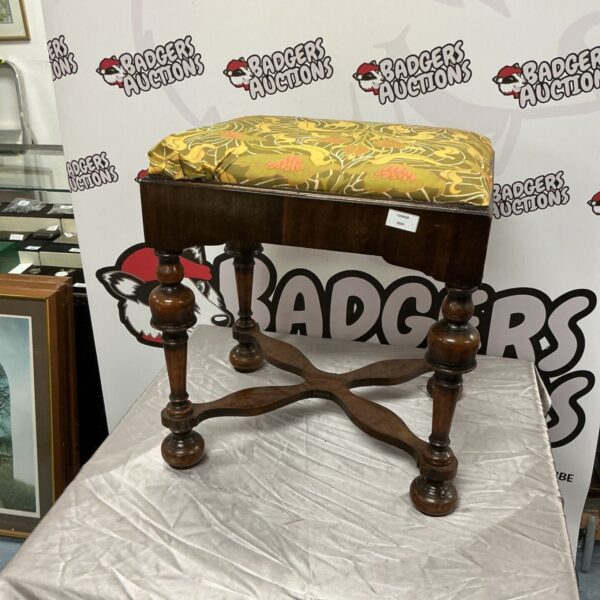 Vintage mahogany stool with floral padded seat and carved legs.
