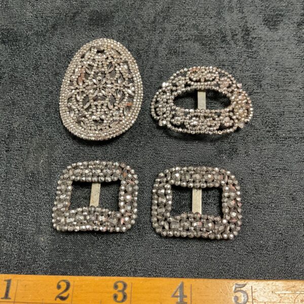 Group of four vintage silver-tone marcasite buckles with varying designs.