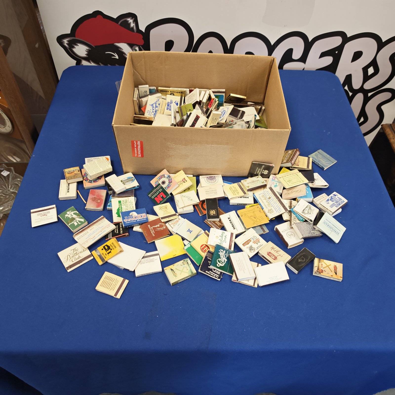 Vintage matchbox collection with diverse designs and advertising graphics.