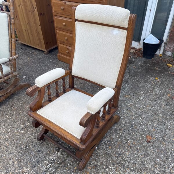 Vintage mechanical rocking chair with upholstered seat and wooden frame.