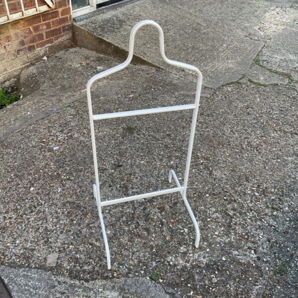 Vintage metal coat stand for hallway storage.