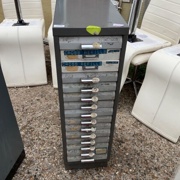 Vintage metal filing cabinet with labelled drawers for storage.