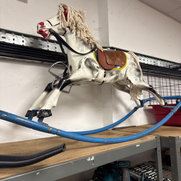 Vintage metal rocking horse, a classic collectible toy for display.