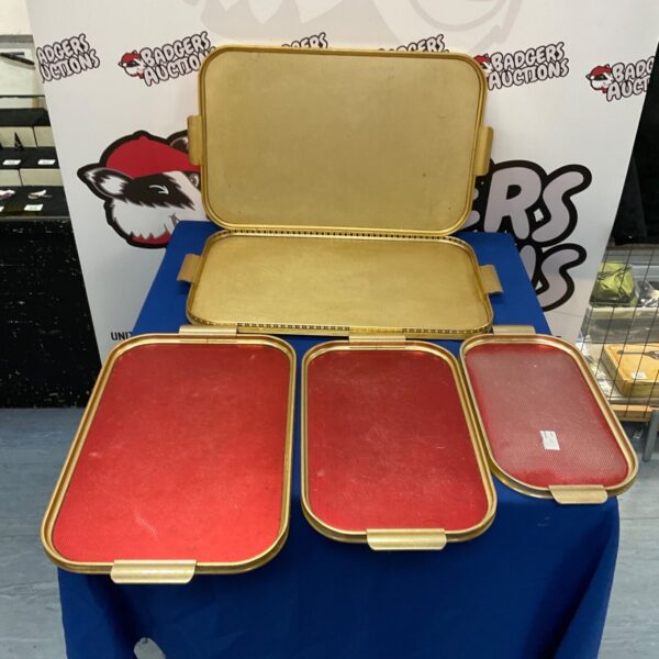 Five vintage metal serving trays displayed together.
